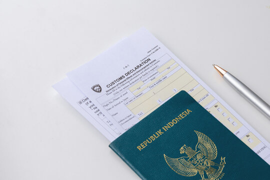 High angle view of Japan Customs Declaration Form C No. 5360-B inside a brown leather passport wallet isolated on white background
