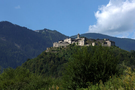 A city on top of a mountain as seen from the road. Europe