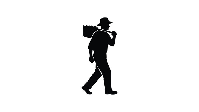Silhouette of a man walking while carrying a sack on his shoulder.