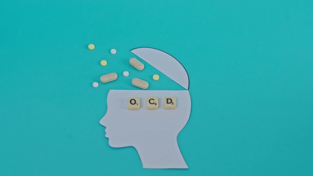 Stop Motion Of Pills And Capsules Filling Paper Brain Silhouette To Illustrate Ocd Treatment