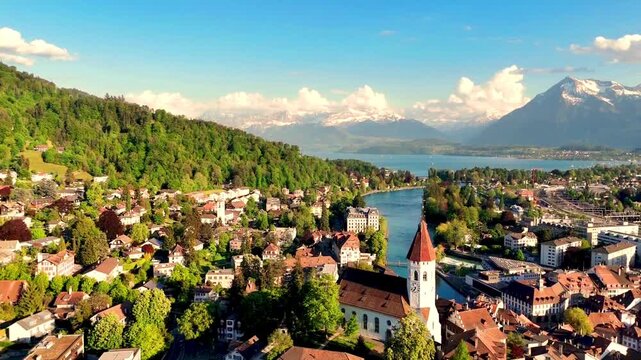 beautiful drone footage of a flight over the alps, an ancient castle, and a panoramic view of the historic city of thun in switzerland.