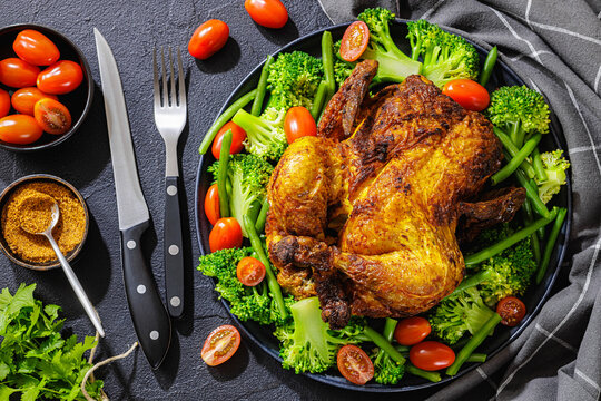 whole roasted chicken with veggies on a plate