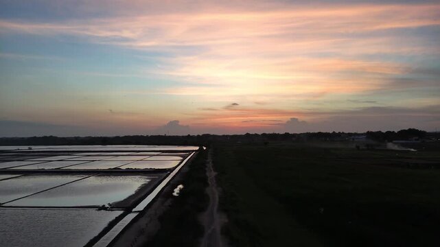 Aerial View of Traditional Salt Pans at Sunset with Beautiful Sky Reflection