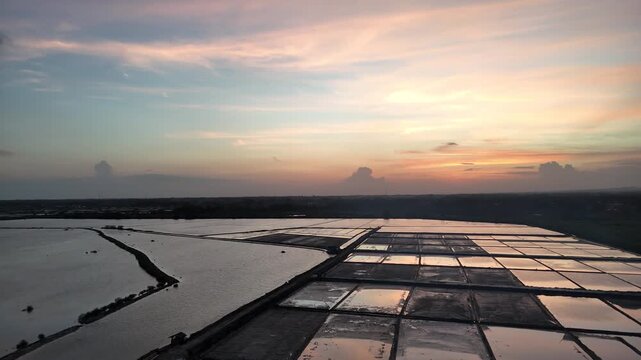 Aerial View of Traditional Salt Pans at Sunset with Beautiful Sky Reflection
