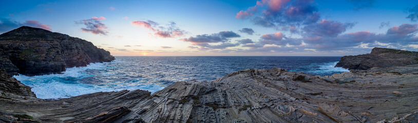 Stintino coast at sunset with rugged rock formations © Luc V. de Zeeuw