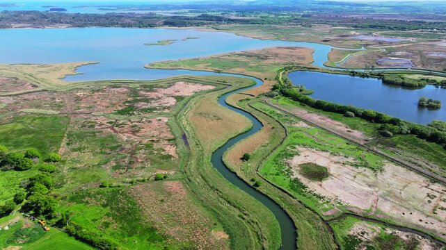 Aerial shot of meandering River Trent or Piddle through Salt Marsh and Reed beds near Poole, UK