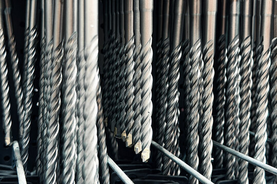 Rows of metal drill bits in a workshop setting