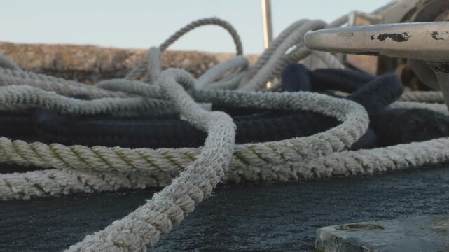 Loose rope on the ground on a boat deck close up low down view stock footage