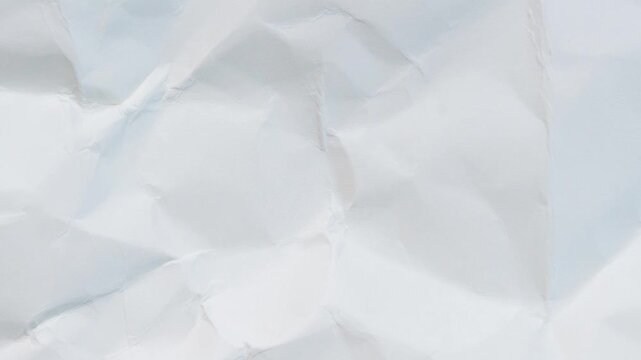 A close-up view of crumpled white paper with a textured surface
