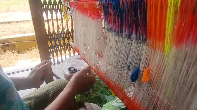Handloom weaver in India working in her loom.