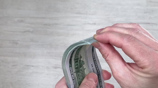 A woman counts banknotes. Women's earnings. Financial independence, income growth and the pursuit of material well-being. Close up