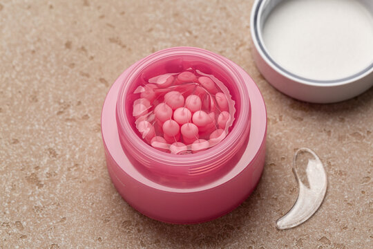 Close up of trendy PDRN, Polydeoxyribonucleotide, Pink Collagen Capsule Cream, skincare solution designed to care for uneven skin tone and spots.