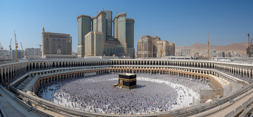 Fototapeta premium A high angle, panoramic shot captures a vast crowd of pilgrims dressed predominantly in white garments performing tawaf around the kaaba in the grand mosque.