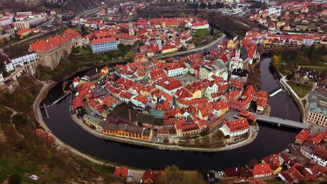 Česk&yacute; Krumlov UNESCO old town rooftops with historic market square, orbiting drone, Czech Republic.