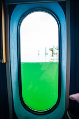 Fototapeta premium Underwater observation window inside the diving gondola at Sellin Pier in the Baltic Sea on Rugen island, Germany. Marine exploration and immersive travel experience concept.