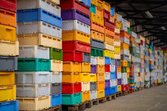 Stacked colorful fish crates at fishing harbor in Sassnitz on Ruegen island, Germany. Maritime industry, logistics and commercial fishing concept.