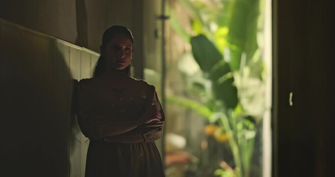 Indian young adult gen z sad stress woman look upset feel bad fail hurt head ache in dark living room. Alone tired female girl think deep suffer low health issue lost job guilt indoor house home place