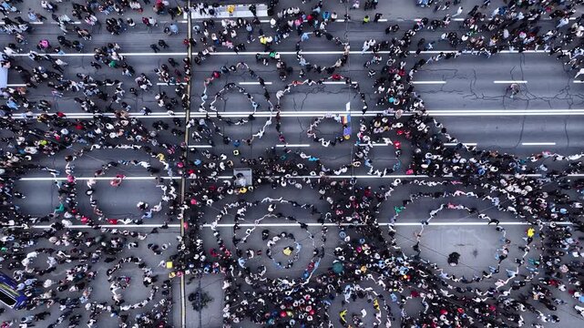 Top down aerial view of people dancing in circles in central Chisinau Moldova