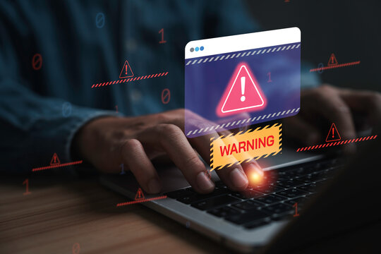 Cybersecurity warning and data protection concept with alert notification on laptop screen, representing cyber attack, online threat, malware detection, system security and network risk management