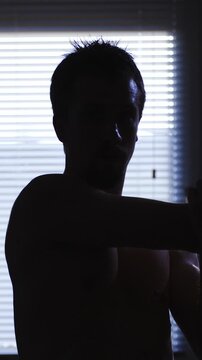 Arm stretching person silhouette at home in slow motion