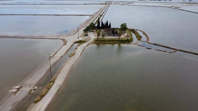 Aerial view of the chapel on a small island with mountains and salt flats