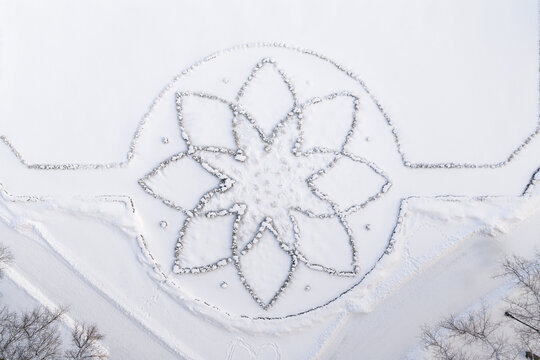 Aerial view of the flower-shaped stone pattern in the snow-covered garden of Traku Voke Manor in Vilnius, Vilniaus apskritis, Lithuania.