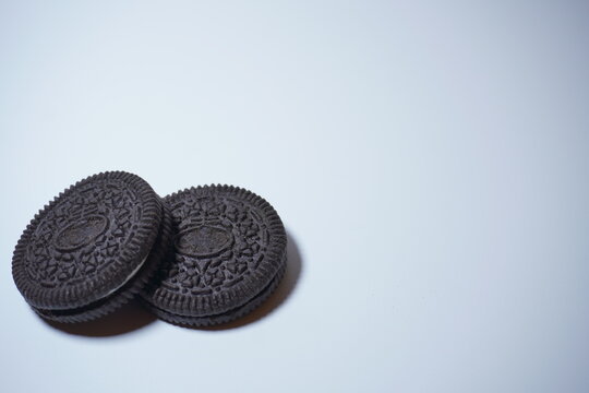 two black biscuits stacked on the bottom left