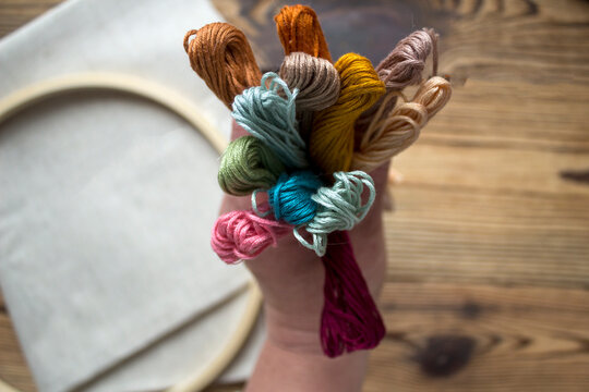 Colorful embroidery floss threads arranged as a bright background. Needlework and craft supplies for a new handmade project. Perfect for sewing, embroidery, DIY hobby, textile design and creative work
