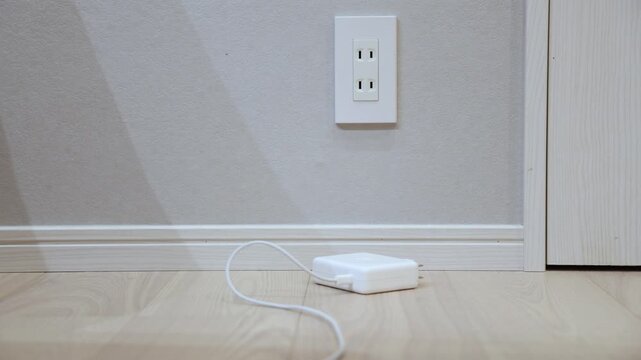 Hand Plugging White Power Strip into Japanese Wall Outlet at Home Lifestyle Video