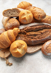 Fototapeta premium Assortment of fresh baked crusty artisan bread and croissants