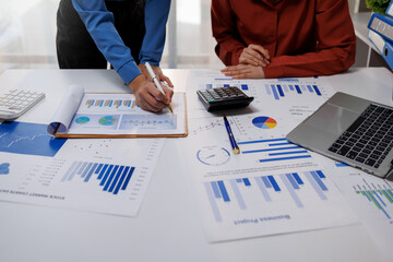 Obraz premium Financial Businesswomen analyze the graph of the company's performance to create profits and growth, Market research reports and income statistics, Financial and Accounting concept.