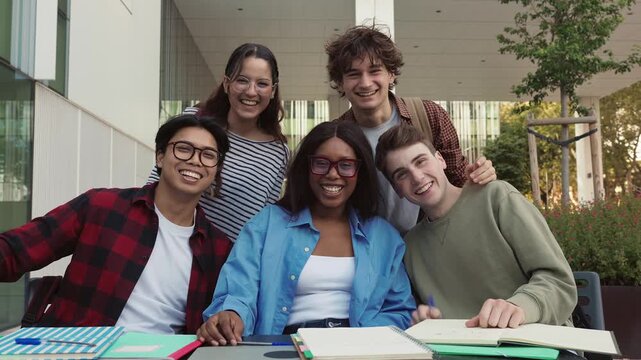 Group of happy multiracial students waving at camera