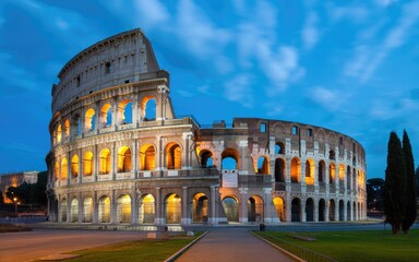 Naklejka premium Dramatic night view of illuminated historic roman colosseum with long exposure light trails