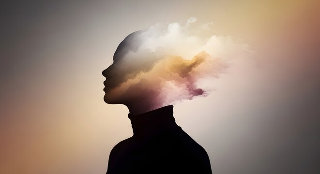 Silhouette profile of a person with clouds inside the head. Creativity and imagination concept. Human head outline merging with soft mist and golden light