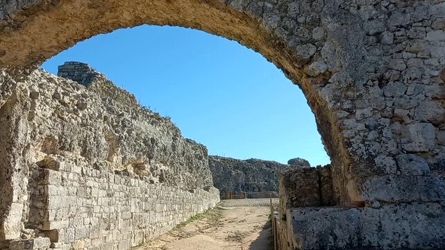 Arch and walls of the Ruins of Conimbriga. The ruins of the Roman city of Conimbriga have been known since the 16th century.