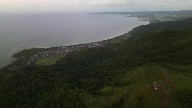 Panoramic aerial view of Mount Lantad overlooking Virac, Catanduanes, Philippines with coastal landscape, forested hills, and distant shoreline
