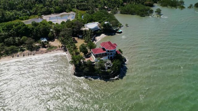 Picturesque aerial drone shot of Roca Encantada heritage house surrounded by coastal landscape in Guimaras, Philippines