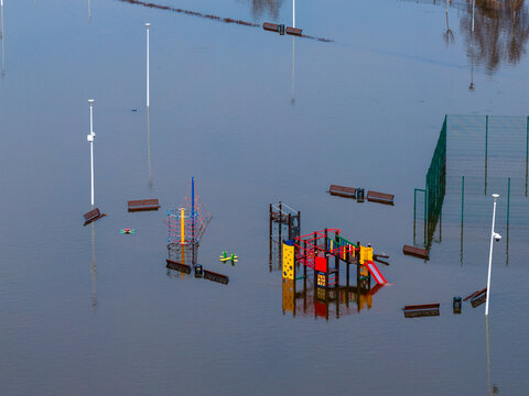 Aerial view of a flooded children's playground with colorful slides and climbing frames submerged in water Kedainiai, Kaunas County, Lithuania.