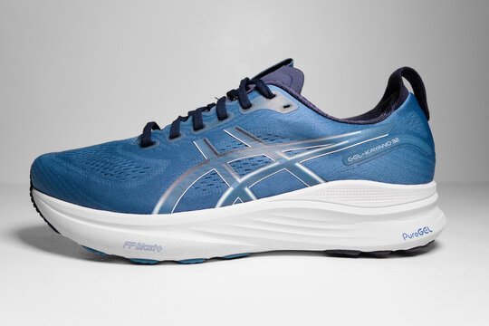 kent, uk, 01.01.2026 ASICS GEL-KAYANO 32 running shoes in Winter Sea Midnight colorway isolated on clean studio background with modern athletic design. Hipster run clubs.