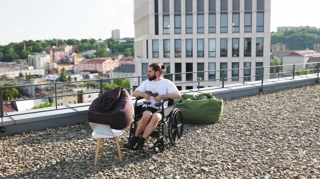 A determined man in a wheelchair performs bicep curls with dumbbells on a rooftop terrace overlooking a city skyline