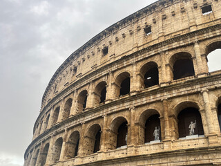 Fototapeta premium Low Angle View of Ancient Roman Colosseum Under Dramatic Cloudy Sky