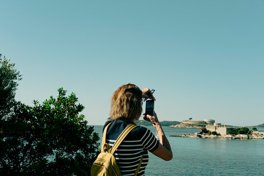 woman traveller and outdoor explorer taking photo of Miriste and Mamula islands in Montenegro