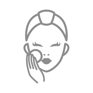 Cleaning face with cotton pad. Woman face cleanser cosmetics routine.