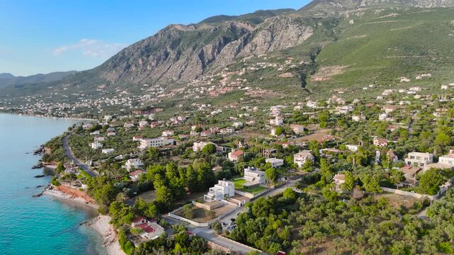 Aerial Drone View of Mikri Mantineia Coastal Village Near Kalamata With Villas, Olive Groves, Mountain Slopes and Blue Mediterranean Sea in Greece