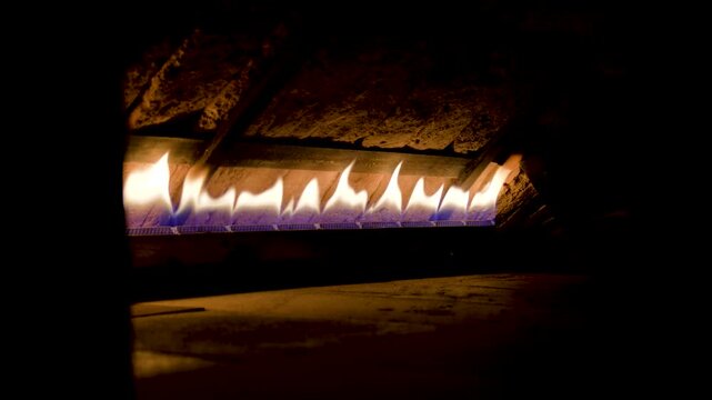 Turkish traditional oven. Fire in the wooden oven. Firewood is burning in the oven, preparation for baking bread.