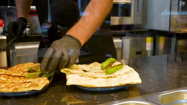 Man making Traditional Turkish pide ramadan pita bread - Ramazan pidesi. Video turkish bread