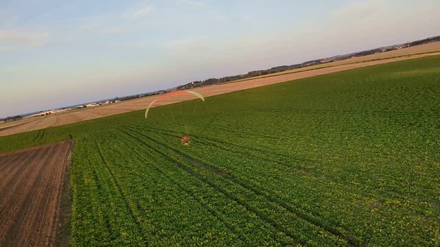 Motorized powered paragliding aerial view showcasing outdoor aviation sport and scenic landscape