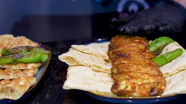 Video Traditional Turkish pide ramadan pita bread served with turkish minced smoked meat - Ramazan pidesi. Video turkish bread