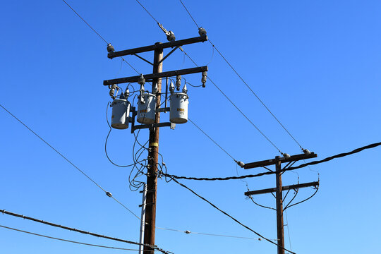 A utility pole with distribution transformers and power lines