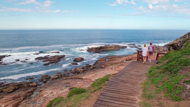 Family hikes on wooden walkway in Robberg Marine Protected Area in Garden Route